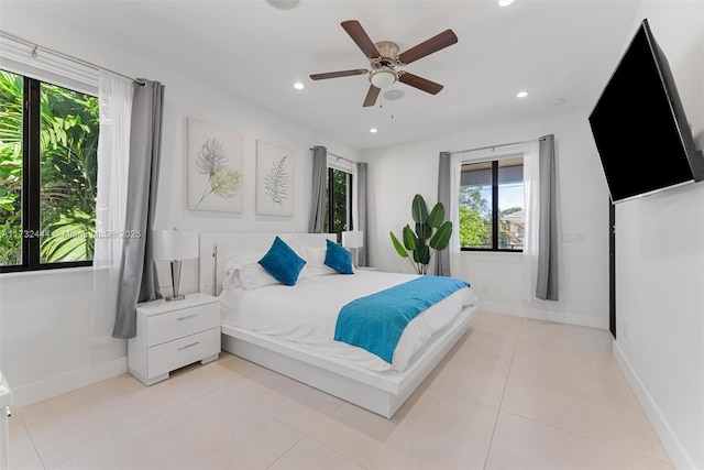 bedroom with ceiling fan and light tile patterned floors