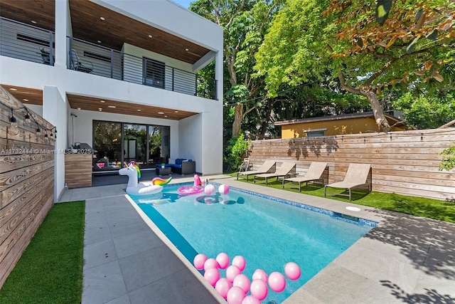 view of swimming pool featuring a patio area