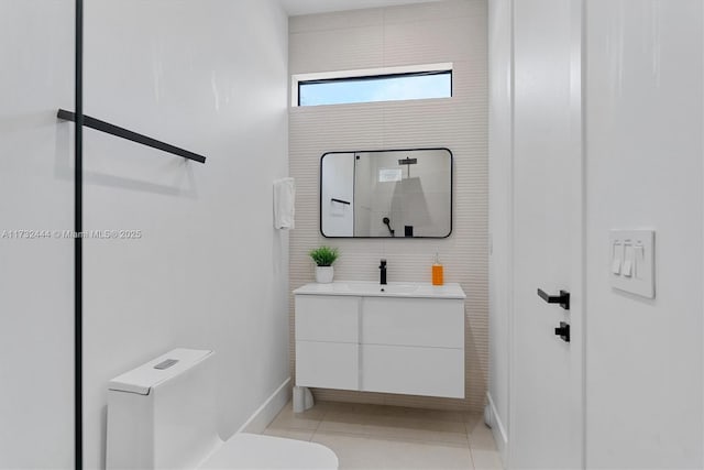 bathroom with vanity, toilet, and tile patterned flooring