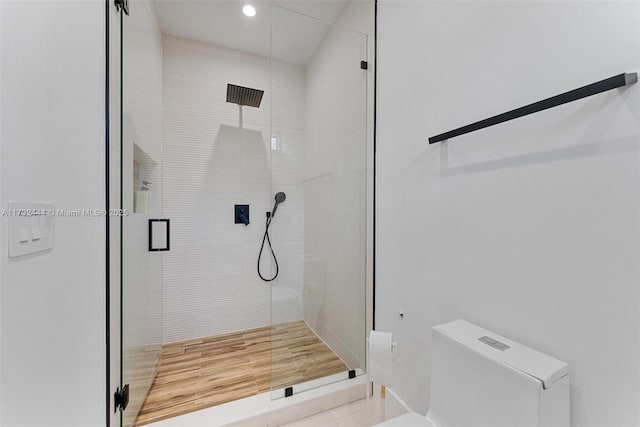 bathroom with walk in shower, tile patterned floors, and toilet