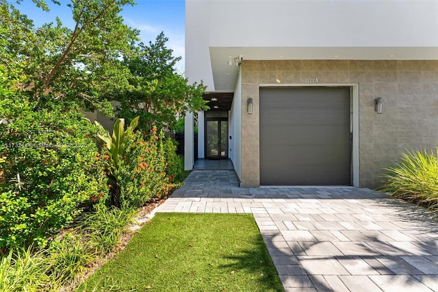 doorway to property featuring a garage