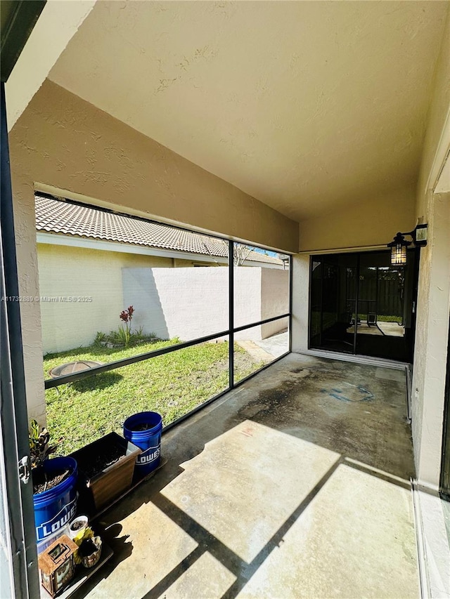 unfurnished sunroom with vaulted ceiling