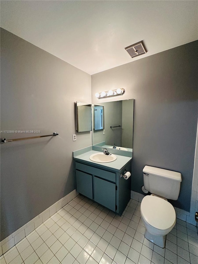 bathroom featuring tile patterned floors, toilet, and vanity