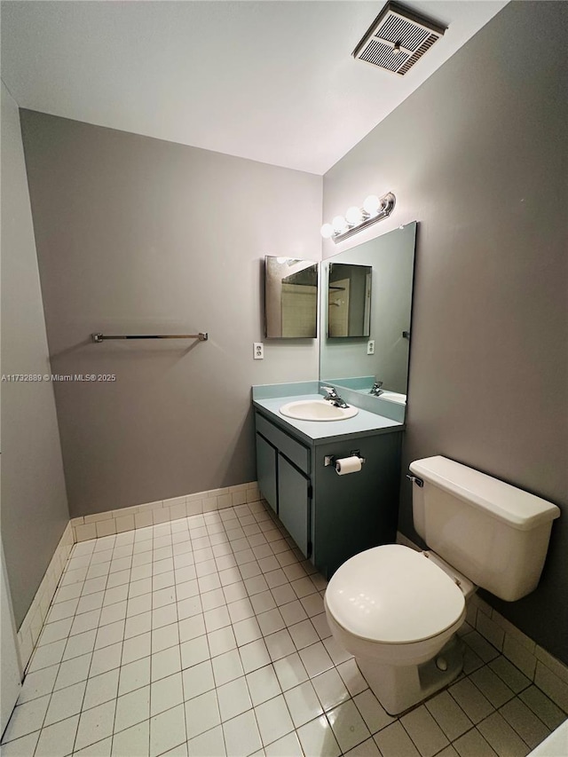 bathroom featuring vanity, toilet, and tile patterned flooring