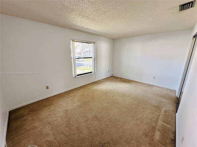 empty room featuring carpet flooring and a textured ceiling