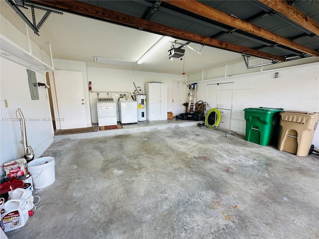 garage with water heater, a garage door opener, electric panel, and washer and dryer