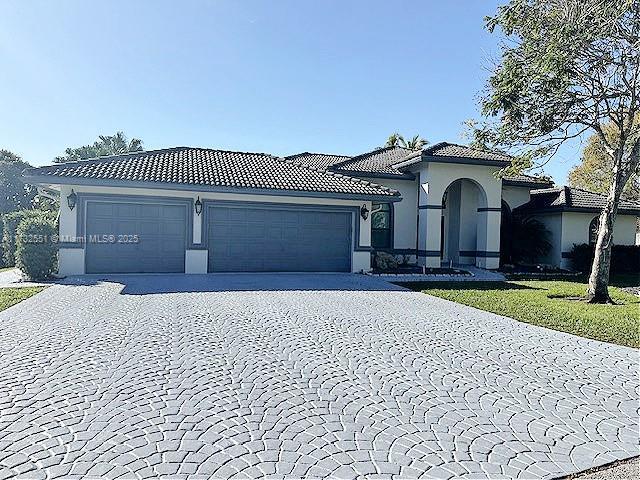 mediterranean / spanish-style house with a garage