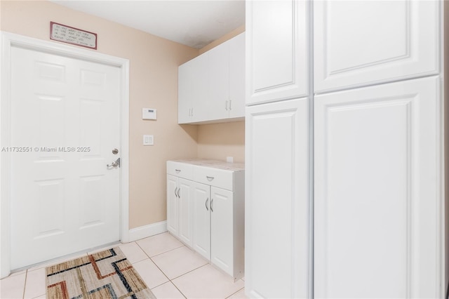 washroom featuring light tile patterned floors and baseboards