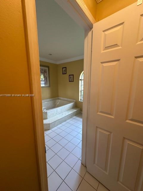 bathroom featuring tile patterned flooring and crown molding