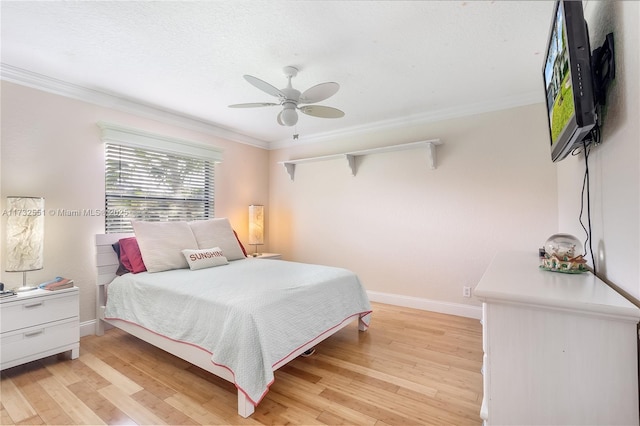 bedroom with baseboards, ceiling fan, light wood finished floors, and crown molding