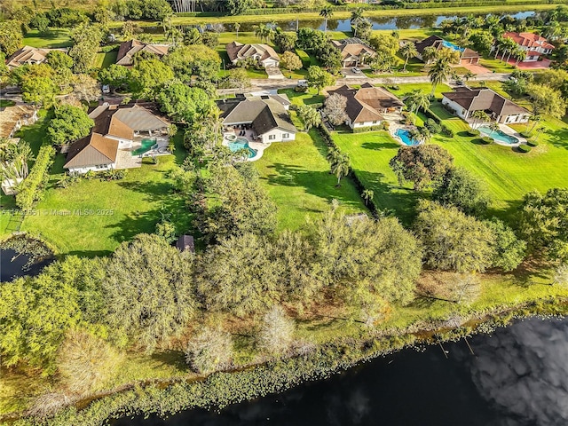 bird's eye view featuring a water view and a residential view