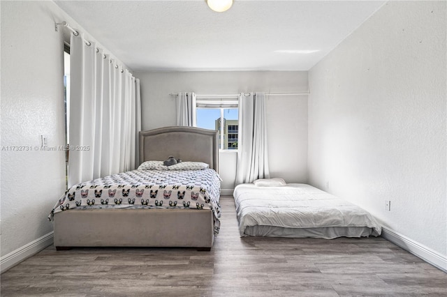 bedroom with hardwood / wood-style flooring