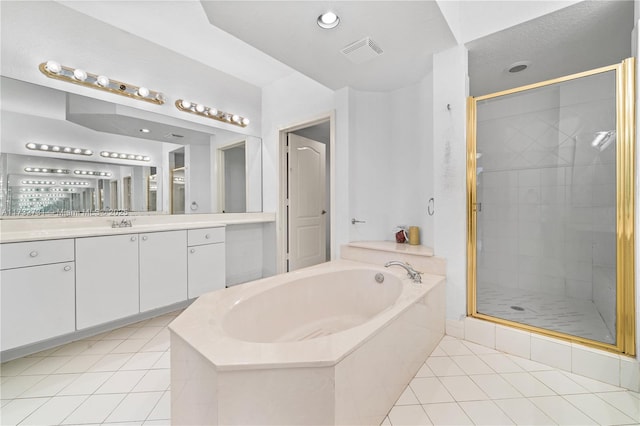 bathroom featuring tile patterned flooring, vanity, and separate shower and tub