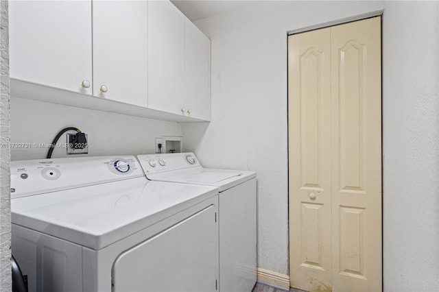 clothes washing area with cabinets and independent washer and dryer