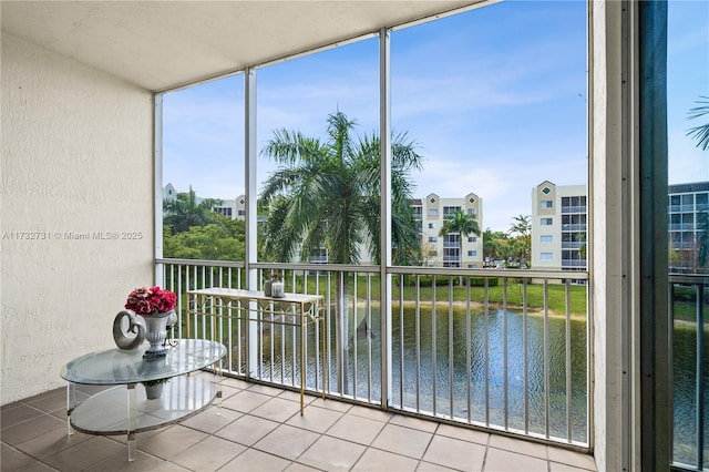 unfurnished sunroom featuring a water view