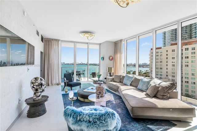 living room featuring a wall of windows and a water view