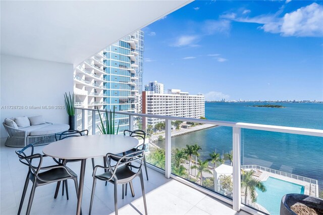 living room with a water view and floor to ceiling windows