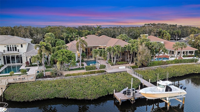 aerial view at dusk with a water view