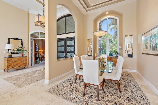 dining space with crown molding and a high ceiling