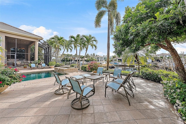 view of patio / terrace with a water view, a pool with hot tub, and a sunroom