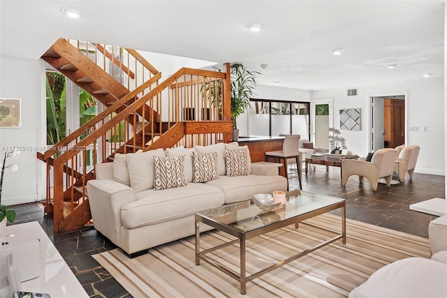 living room with baseboards, stairs, visible vents, and recessed lighting