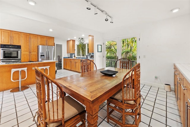 dining area featuring baseboards, track lighting, light tile patterned flooring, and recessed lighting