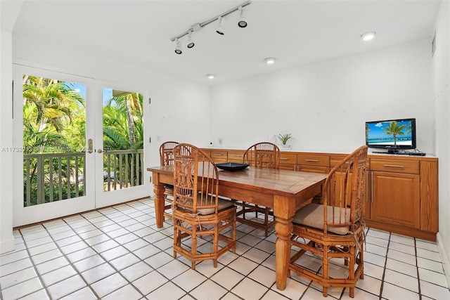 dining room with light tile patterned floors, french doors, and track lighting