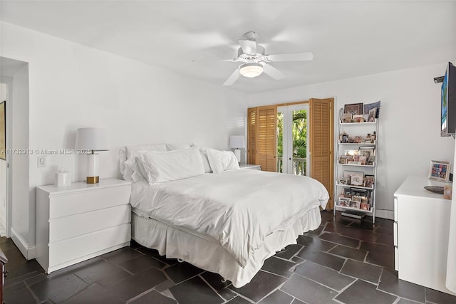 bedroom with ceiling fan, access to outside, and baseboards