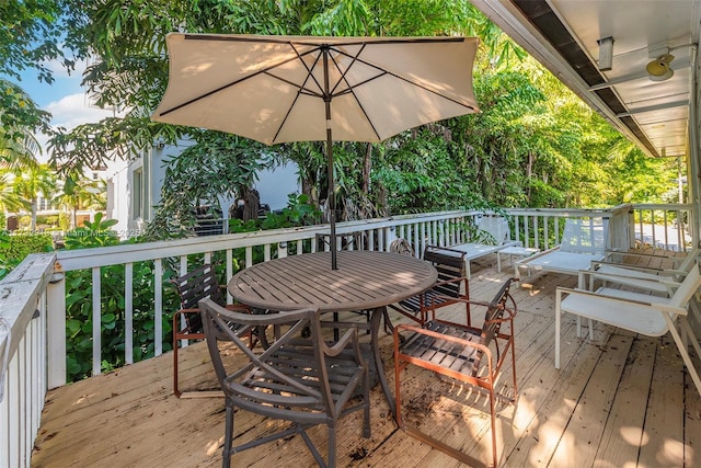 wooden deck featuring outdoor dining area