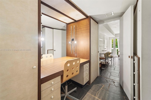 office with visible vents and stone tile flooring