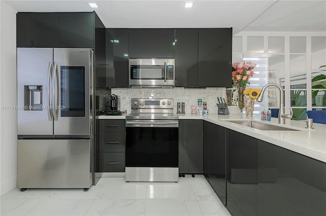 kitchen with tasteful backsplash, stainless steel appliances, and sink