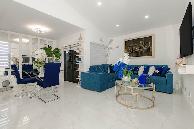 living room featuring lofted ceiling