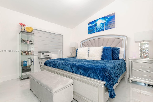 bedroom with lofted ceiling and light tile patterned floors