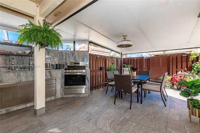 view of patio featuring ceiling fan and area for grilling