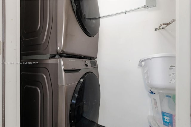 clothes washing area featuring stacked washer and dryer