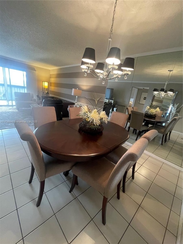 dining area featuring an inviting chandelier, tile patterned flooring, and a textured ceiling