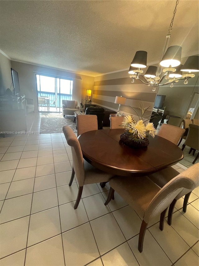 dining area with tile patterned flooring, a chandelier, and a textured ceiling