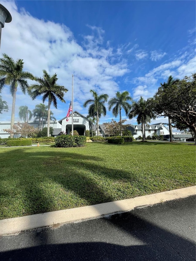 view of property's community with a lawn