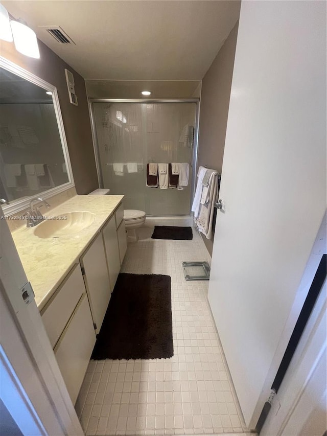 bathroom with vanity, toilet, and walk in shower