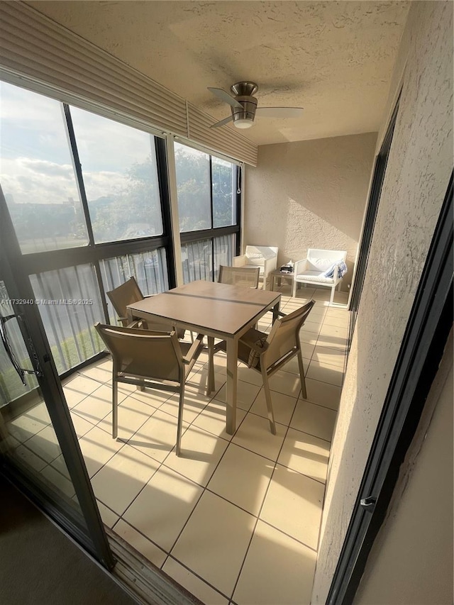 sunroom / solarium featuring ceiling fan