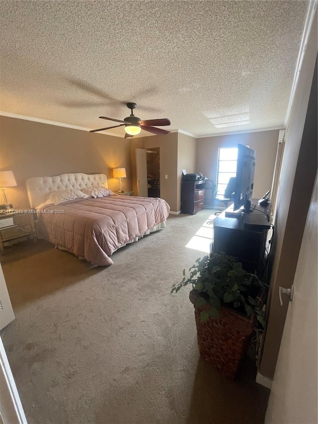 bedroom featuring ornamental molding, carpet floors, a textured ceiling, and ceiling fan