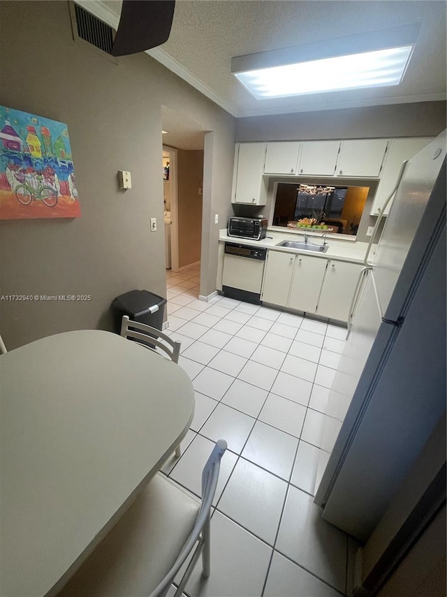 kitchen with sink, crown molding, fridge, white dishwasher, and white cabinets