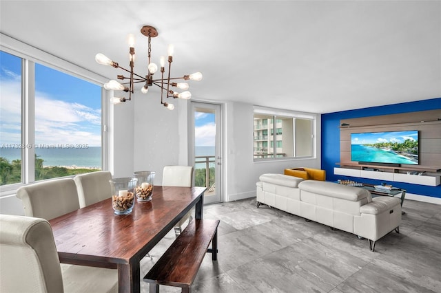 dining area with a chandelier and a water view