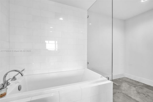 bathroom featuring tiled tub