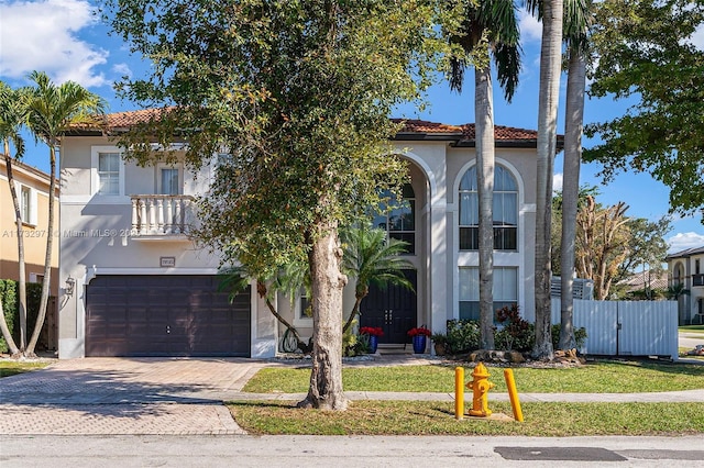 mediterranean / spanish-style home with a garage