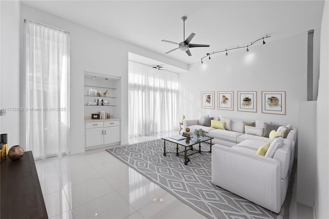 tiled living room featuring built in features and ceiling fan