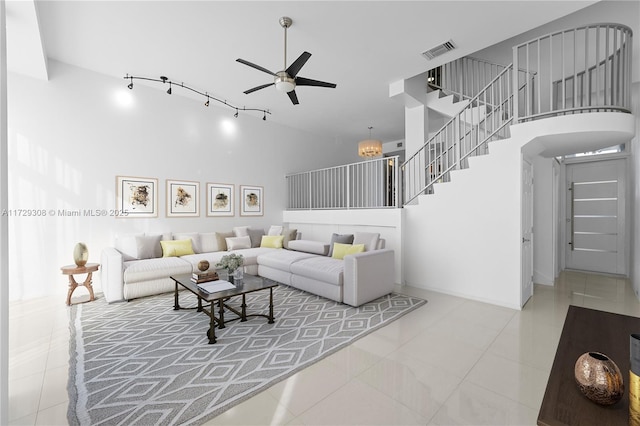 tiled living room featuring a high ceiling and ceiling fan