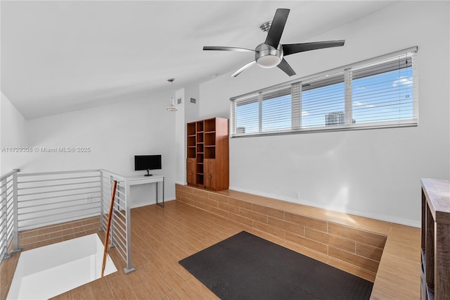 exercise area with lofted ceiling and light hardwood / wood-style floors