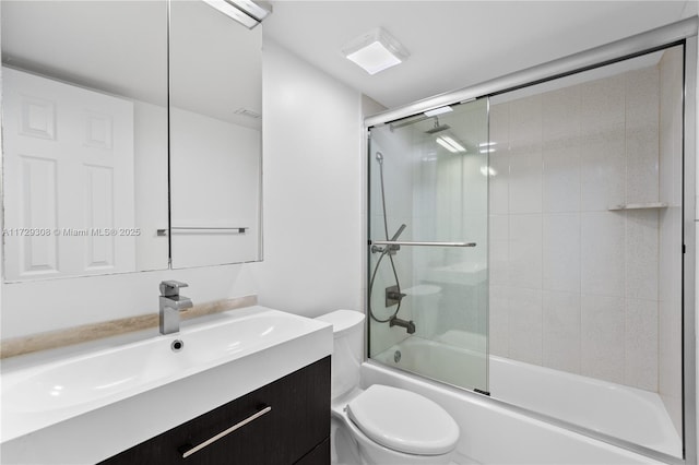 full bathroom with vanity, combined bath / shower with glass door, and toilet