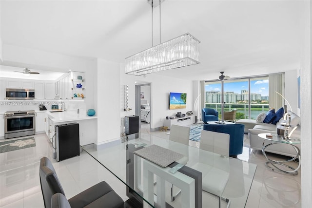 dining space featuring floor to ceiling windows and ceiling fan